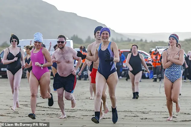 Hundreds of swimmers brave icy waters for traditional New Year’s Day dip in Whitley Bay, North Tyneside